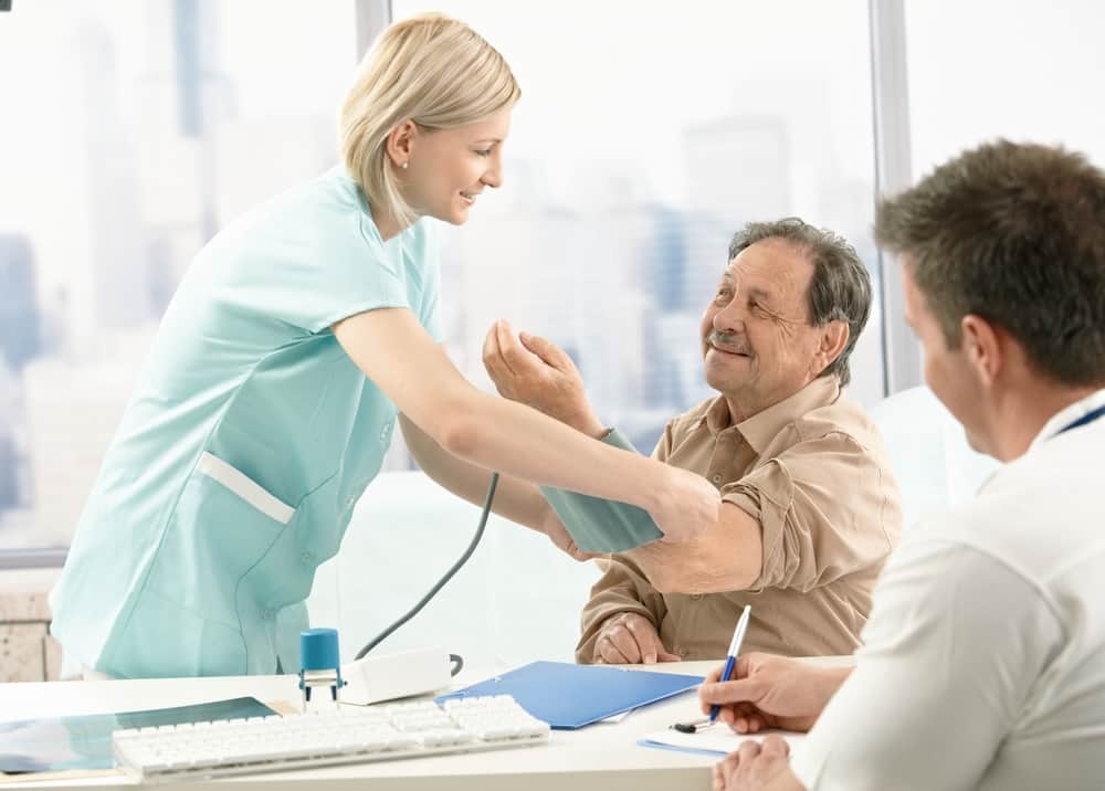 Doctor checking blood pressure of patient