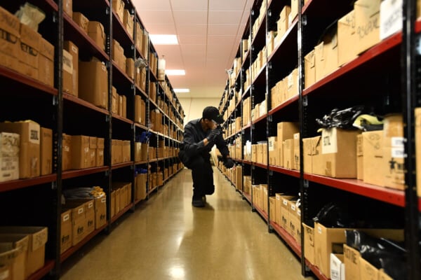 Terminix tech inspecting boxes in a warehouse