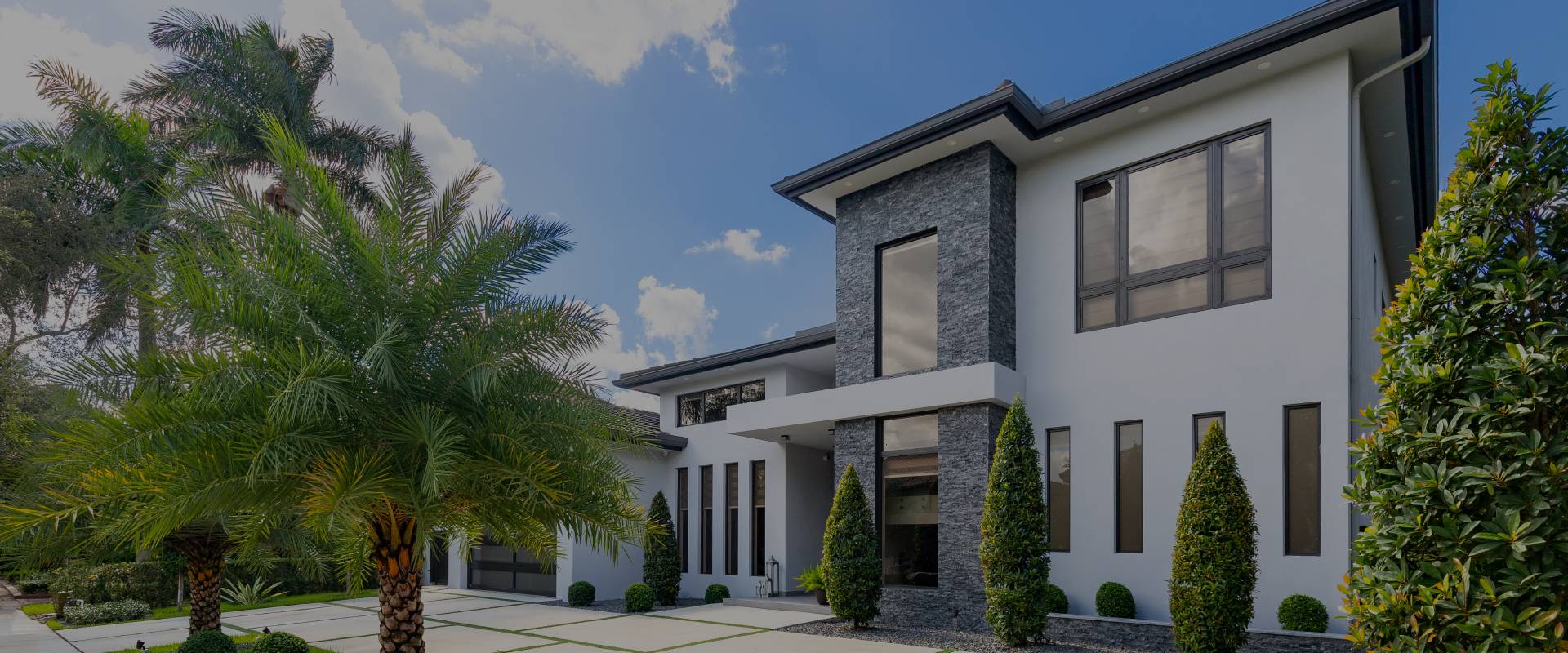 Modern style home with palm trees in front