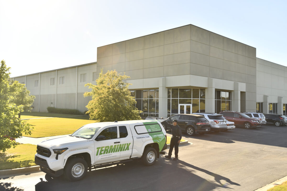 Terminix truck and colleague in front of a warehouse